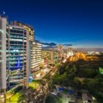 Dynamic night skyline of Dar es Salaam, showcasing illuminated city architecture.